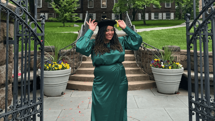 Brittany L. Marshall dressed in a green cap and gown