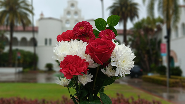 A bouquet of Valentine's Day flowers on a misty afternoon in front of Hepner Hall on the campus of San Diego State University 