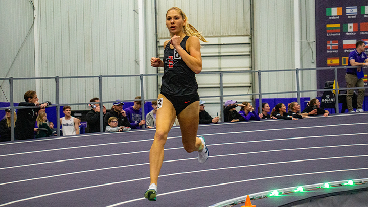 Sophia Wolf shown running on an indoor track during competitions.