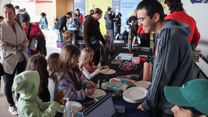 Members of SDSU’s Society of Hispanic Professional Engineers (SHPE) work with students to construct designs out of marshmallows and pasta. (Bryana Quintana/SDSU)