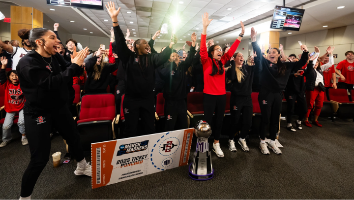 SDSU women's team celebrates their conference championship in the locker room