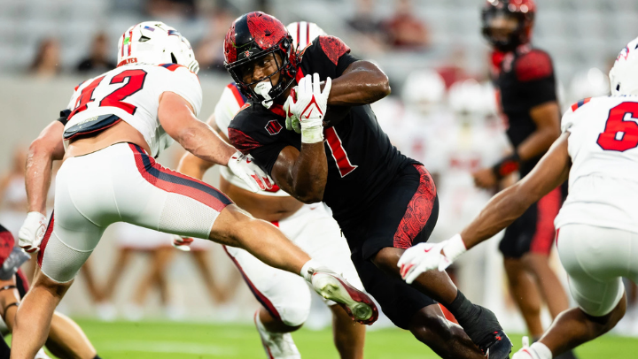 Running back Lucky Sutton breaks through Stony Brook defenders during SDSU's season opener at Snapdragon Stadium. Sutton rushed for a career-high 100 yards and scored two touchdowns in SDSU's 42-0 win. (SDSU)