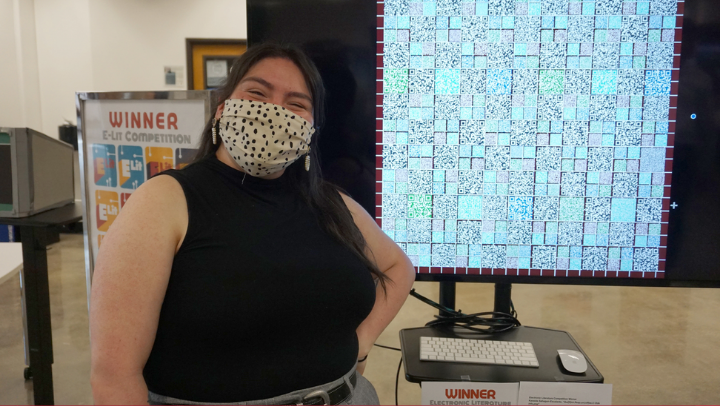 Kasside Sahagun-Escalante, co-winner, presents her QR code quilt project at the E-Lit Competition in the University Library on May 9. (SDSU)